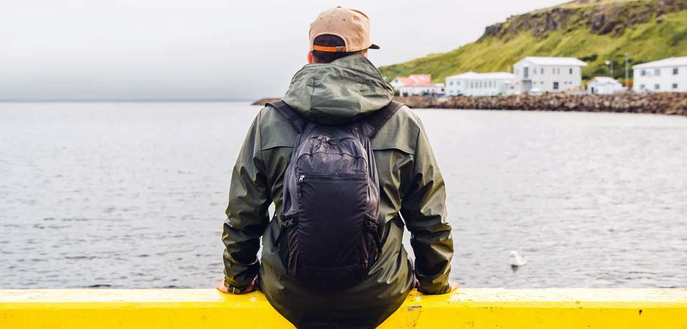 man wearing travel backpack