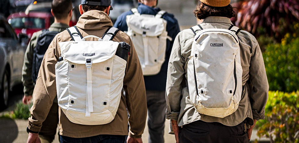 Four guys walking with backpacks