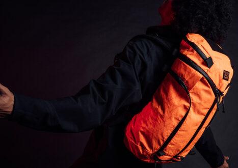 man with orange backpack