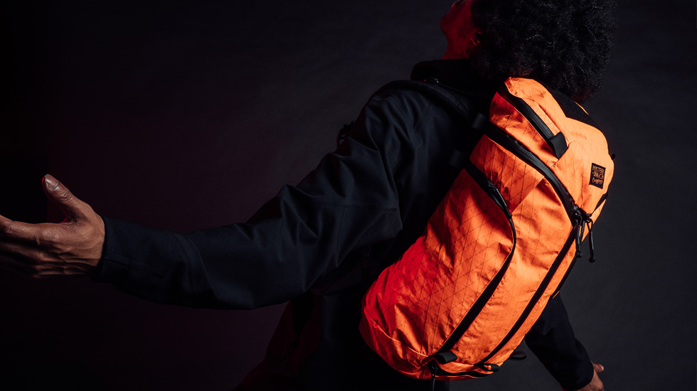 man with orange backpack