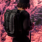 model with backpack on in front of mars image