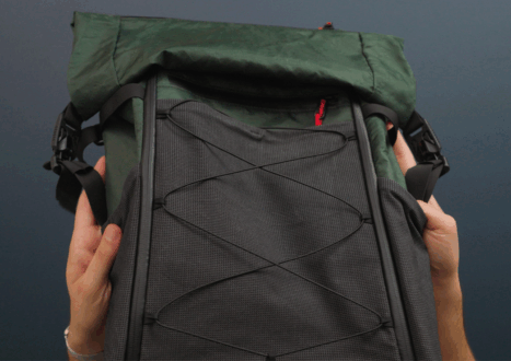 lightweight backpack being packed by a set of hands