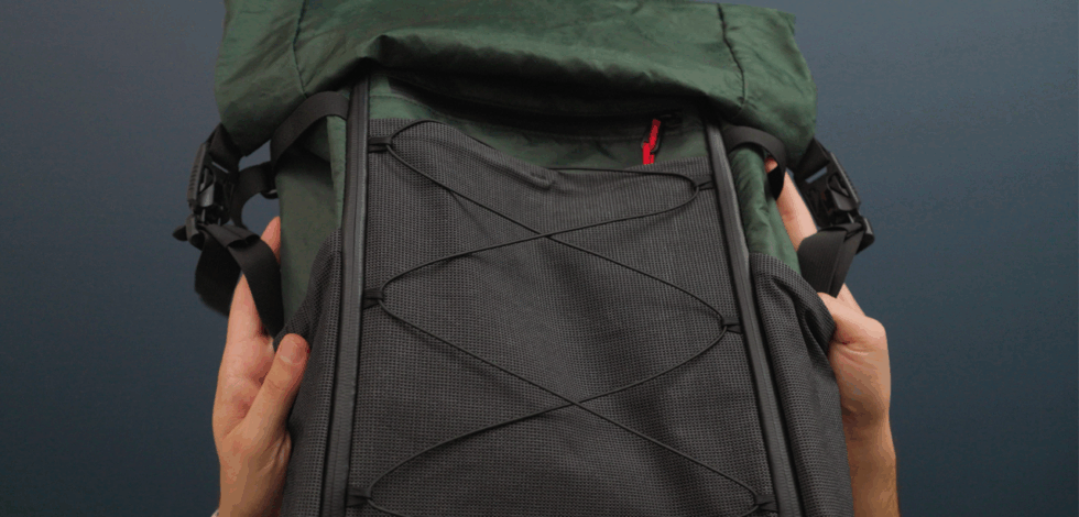 lightweight backpack being packed by a set of hands