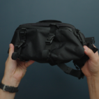 hands holding black sling