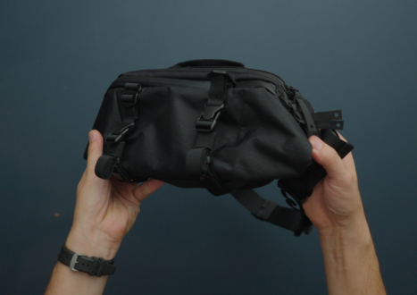 hands holding black sling