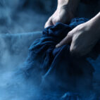 japanese craftsperson with hands in indigo vat