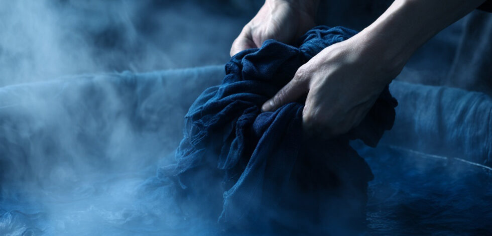 japanese craftsperson with hands in indigo vat