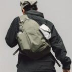 model wearing sling on grey background